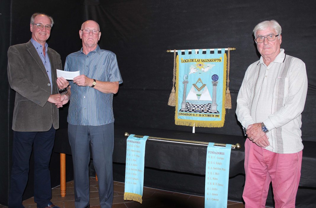 Past Worshipful Master, Brian McArdle, making the presentation to the President of Reach Out, Brian Procter, in the presence of Charity Steward, Vernon Sayce.