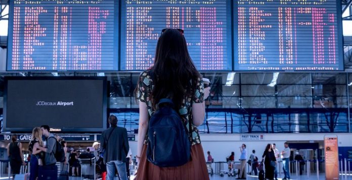 Teenager looking at flight board