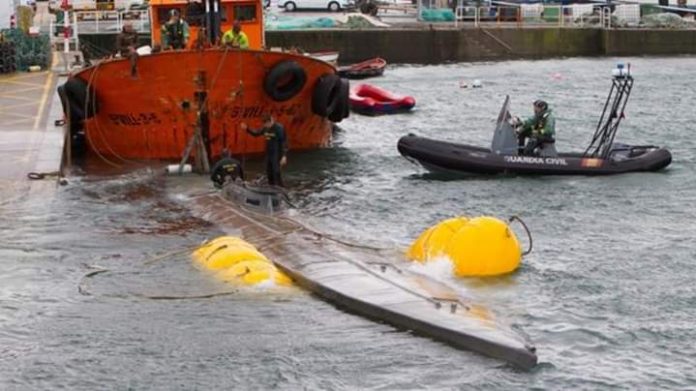 Rain and gales made it difficult for the scuttled sunken submarine to be brought into port by police.