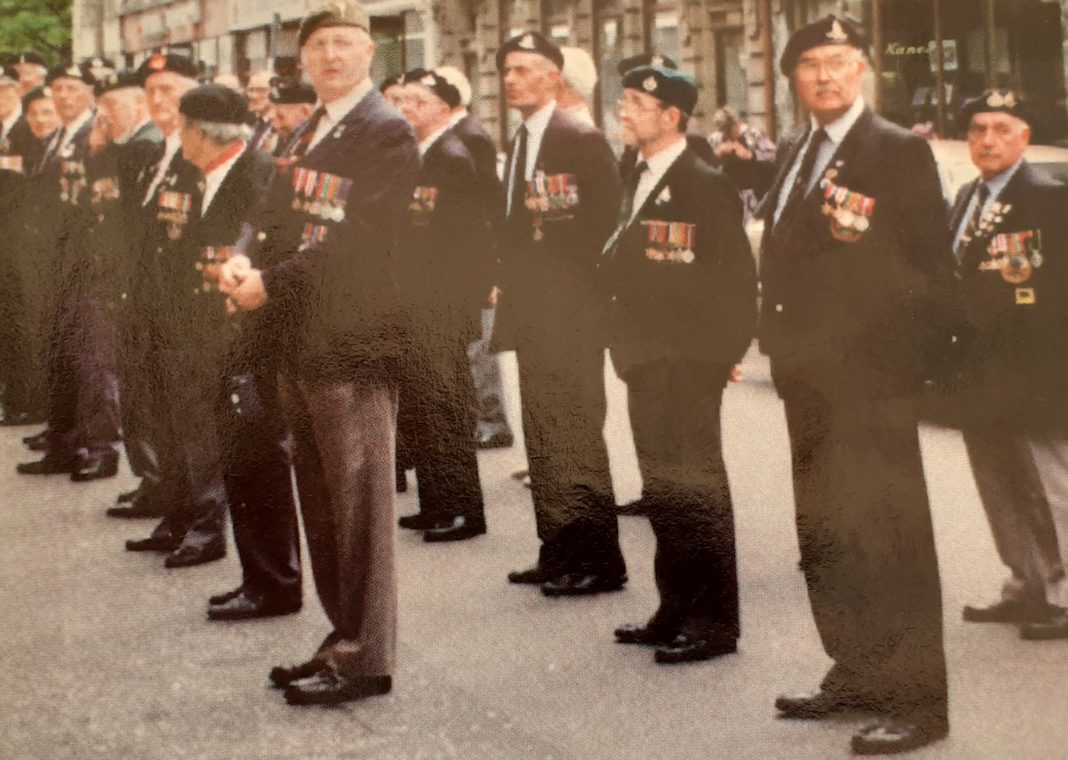 Jim, front of photograph, marking D-Day, King Street, Whitehaven.