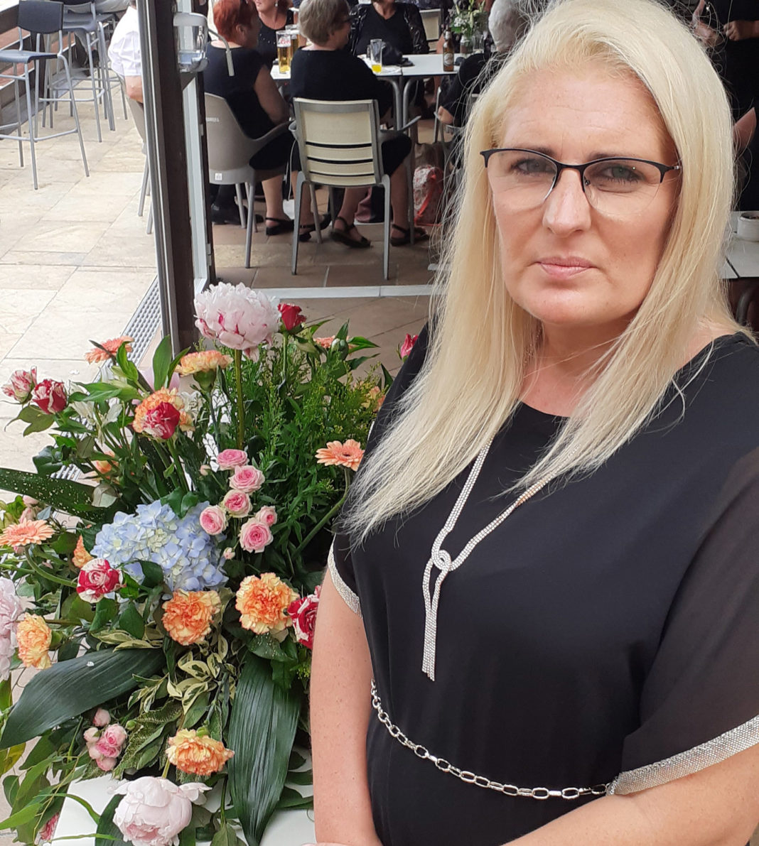 Julie O'Neill pictured with a bouquet of flowers at the Memorial service. Photo: Andrew Atkinson (c).