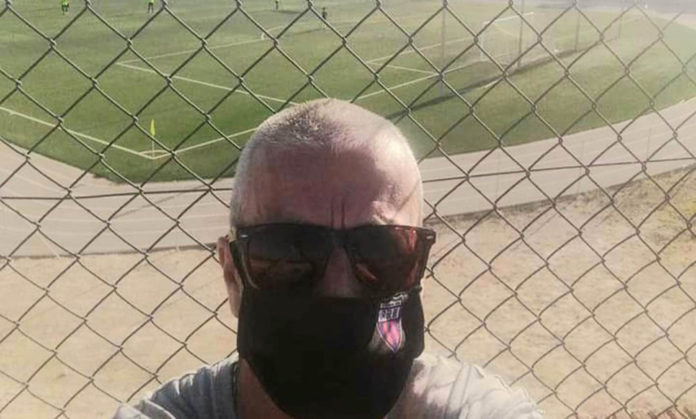 Racing San Miguel masked fan Steve Dobson watched Racing v Catral CF outside the stadium, due to COVID-19 behind closed doors protocol.