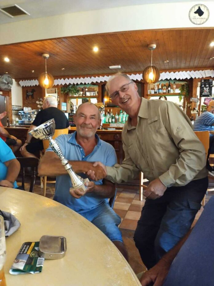 The photo is of Russ receiving his trophy from CRU President, Roy Dainty