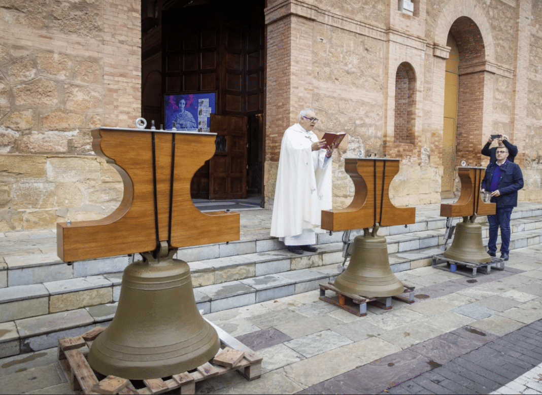 The parish priest, José Antonio Gea, blesses the three bells outside the Church of the Immaculate Conception