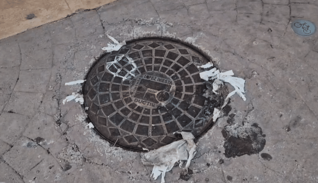 The manhole cover was displaced by the upward pressure of the sewerage which flooded much of the promenade
