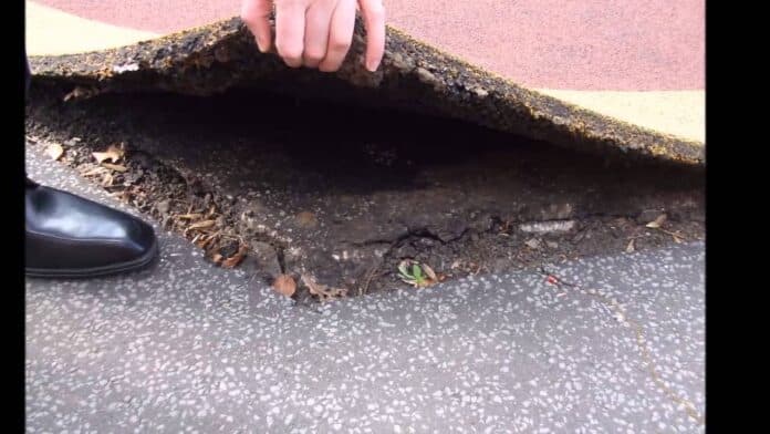 The child tripped on a raised rubber tile. Instead of cushioning his fall, the hardened, uneven surface sent him tumbling forward, splitting open his chin.